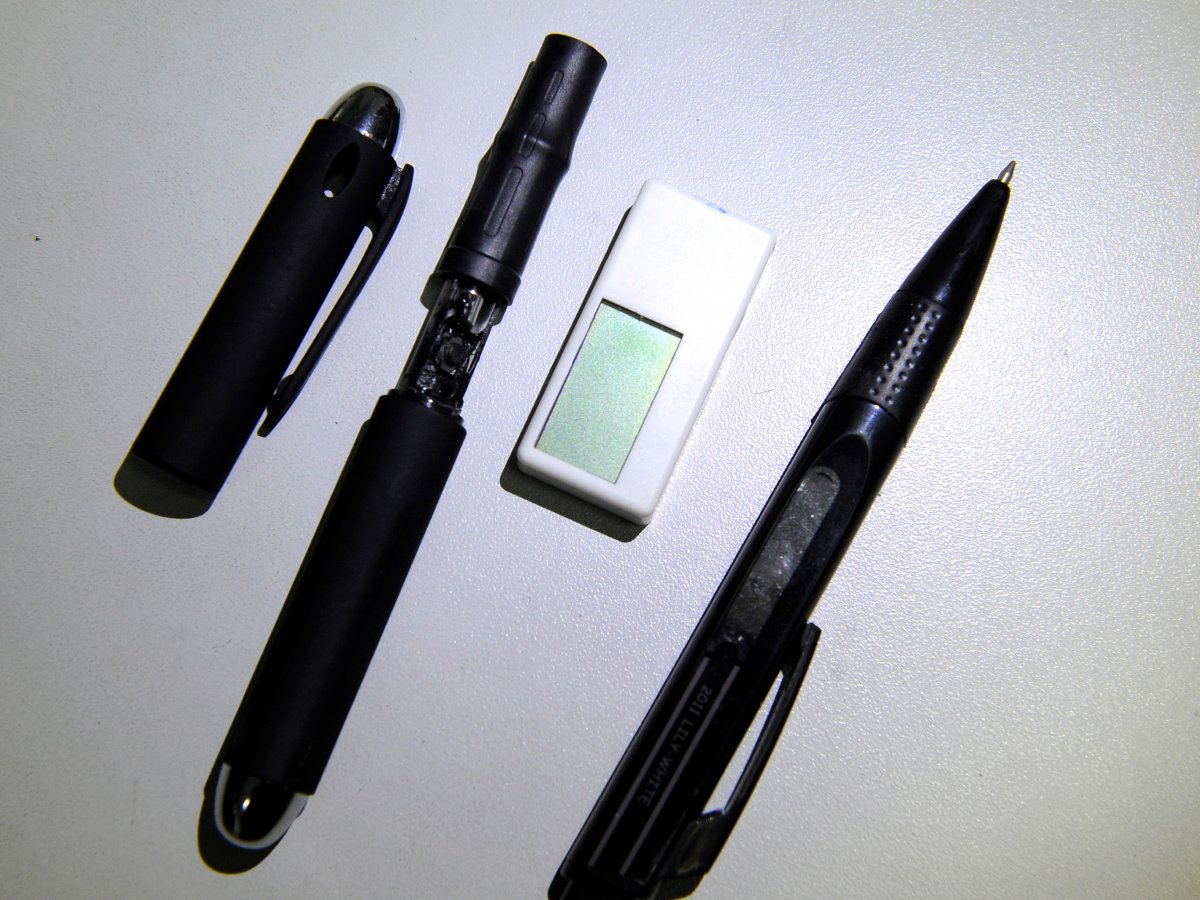 A hidden camera inside a pen (second from the left) and a receiver disguised as an eraser were confiscated by police.