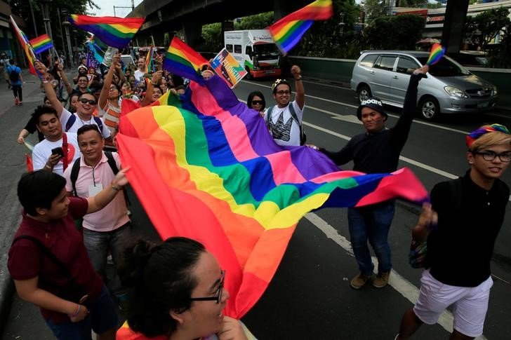 Supporters wave rainbow flags while marching during a LGBT Pride parade in metro Manila, Philippines June 25, 2016. REUTERS/Romeo Ranoco