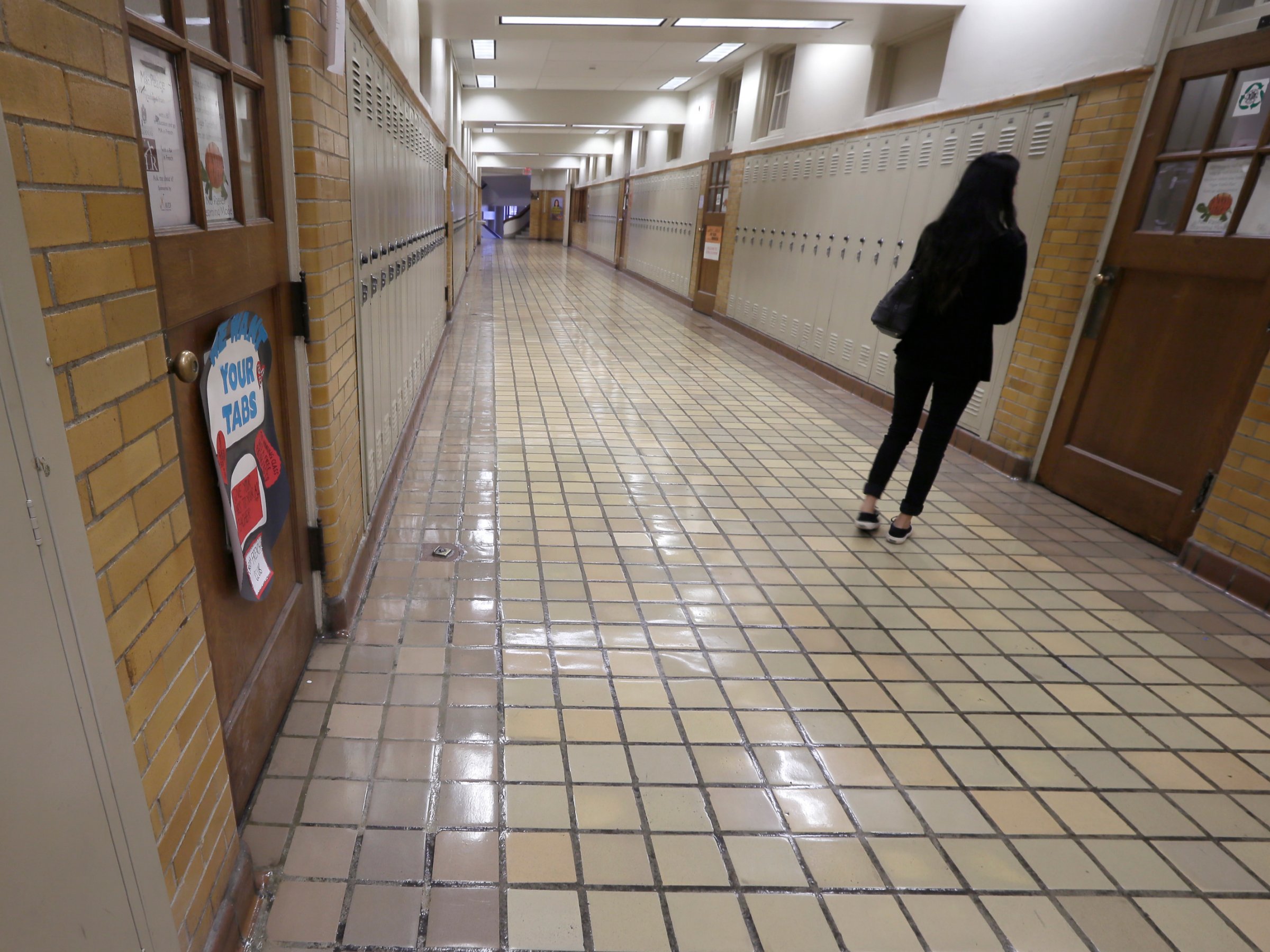 A student walks in a hallway at Little Rock Central High School in Little Rock, Ark., Monday, Jan.13, 2014.