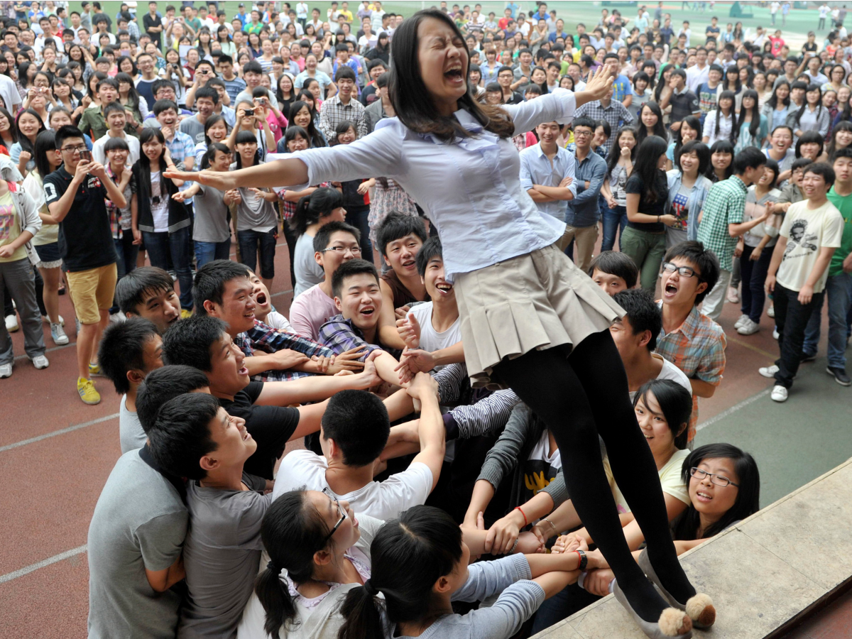 It's not all work. Leading up to the exam, students and teachers take part in pressure-release activities, like this trust-fall.