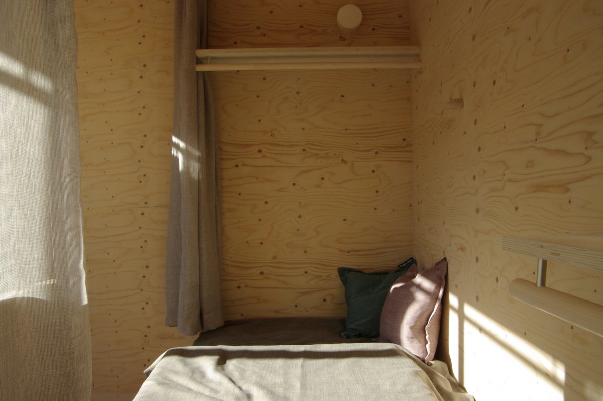 The prototype features a dining area, bathroom, storage, workspace, kitchen, and a bedroom that can fit a twin size bed.