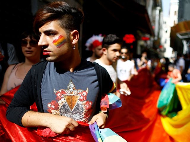 LGBT rights activists hold a rainbow flag during a transgender pride parade which was banned by the governorship, in central Istanbul, Turkey, June 19, 2016. REUTERS/Osman Orsal