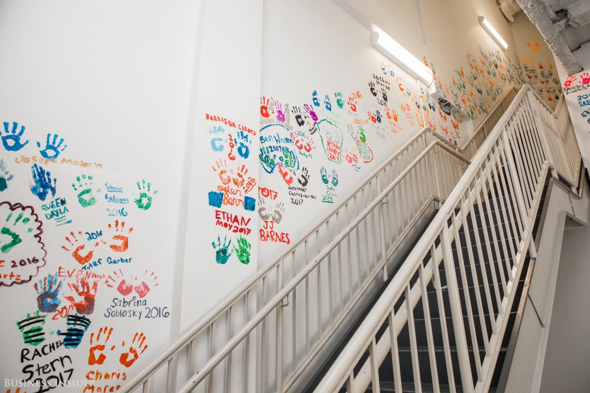 Walking up a staircase we were met with students' hand prints and their class year.